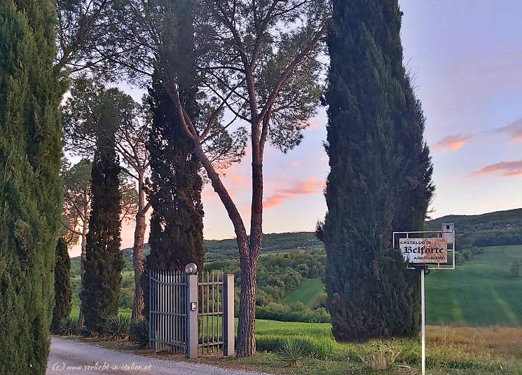 Schild beim Gartentor Castello di Belforte vor umbrischer Landschaft